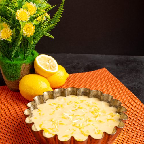 front-view-delicious-lemon-cake-sour-delicious-exotic-bakery-cake-sweet-dark-desk