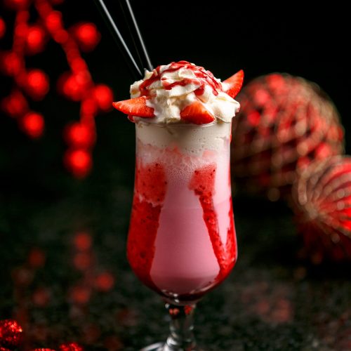 strawberry milkshake with ice on the table