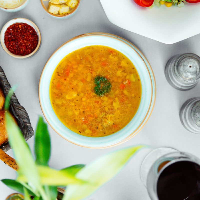 top view of vegetable soup with broccoli cucumber potato and tomato